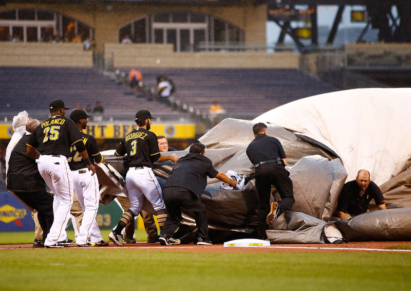 Illustration for article titled It Takes A Village To Secure An Infield Rain Tarp
